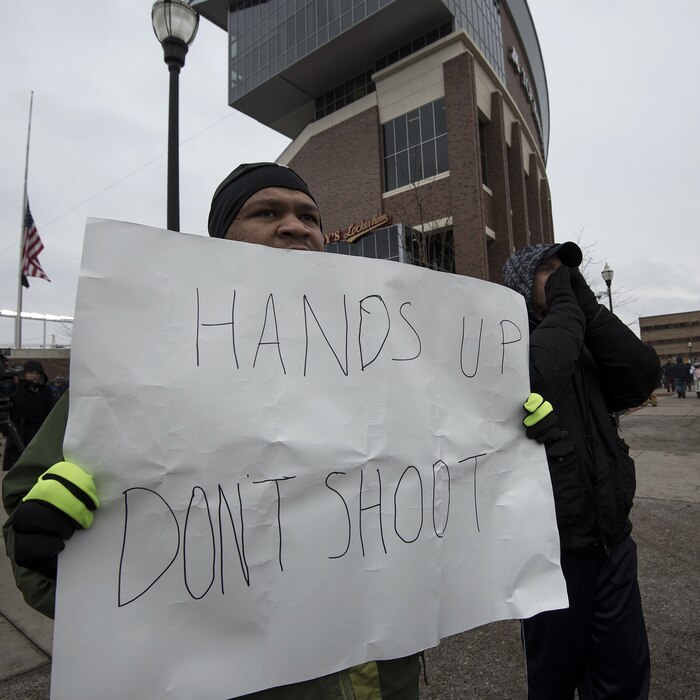 Protester holding a sign reading Hands up, don't shoot, Minneapolis, 2014